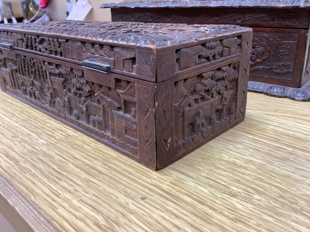 Two 19th century Chinese carved sandalwood boxes, together with a similar puzzle box, length 27cm